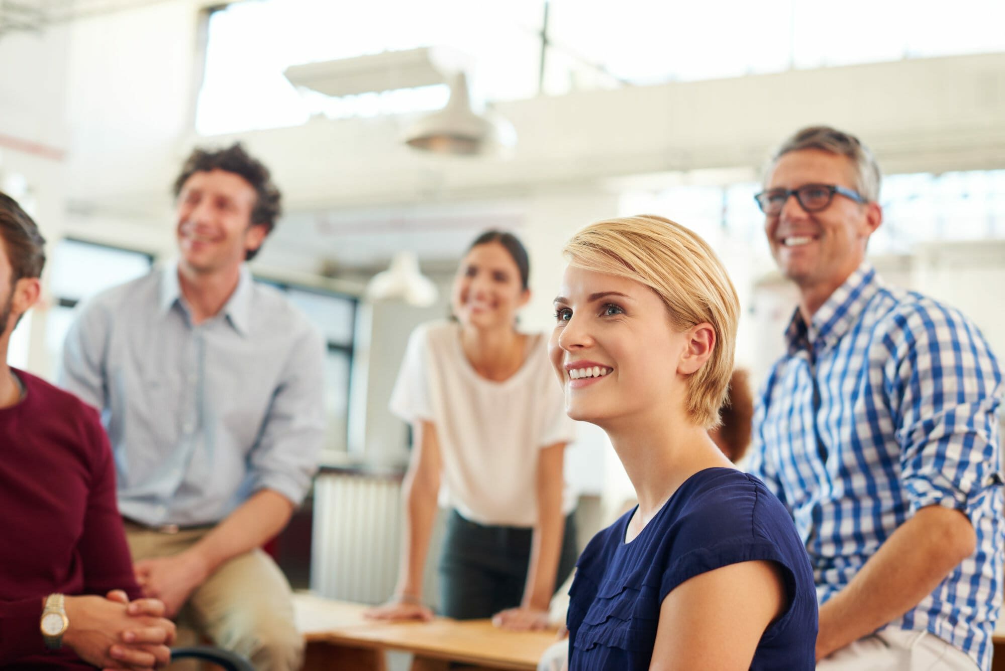 A group of people in an office eager to begin their eLearning course design project