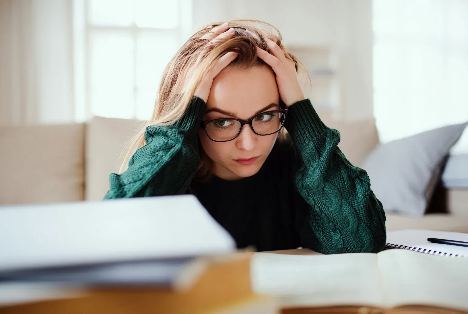 A bored, frustrated learner wearing glasses is not engaged.