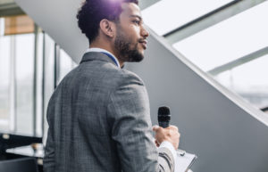 Portrait of a Businessman Holding Microphone